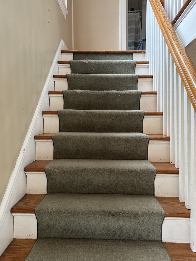 staircase with wood finished floors