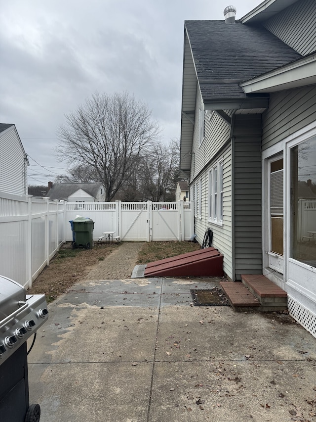 view of patio featuring a fenced backyard and a gate