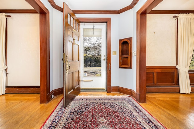 entrance foyer featuring parquet flooring, baseboards, and ornamental molding