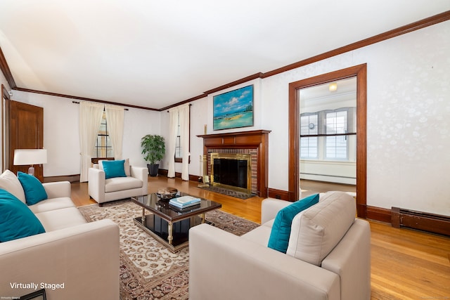 living room with a baseboard radiator, wood finished floors, and ornamental molding