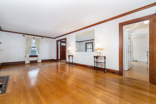 unfurnished living room with wallpapered walls, hardwood / wood-style flooring, baseboards, and baseboard heating