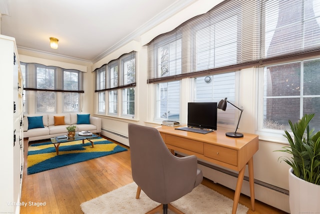 office space featuring hardwood / wood-style flooring, crown molding, and a baseboard radiator