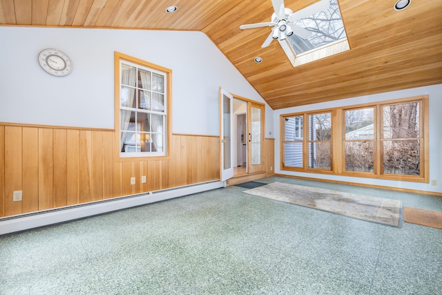 unfurnished sunroom featuring lofted ceiling with skylight, wood ceiling, a baseboard heating unit, and ceiling fan