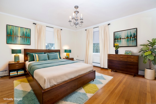 bedroom featuring a baseboard heating unit, light wood-type flooring, baseboard heating, and ornamental molding