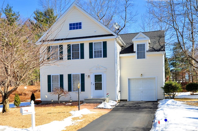 view of front of property with a shingled roof and aphalt driveway