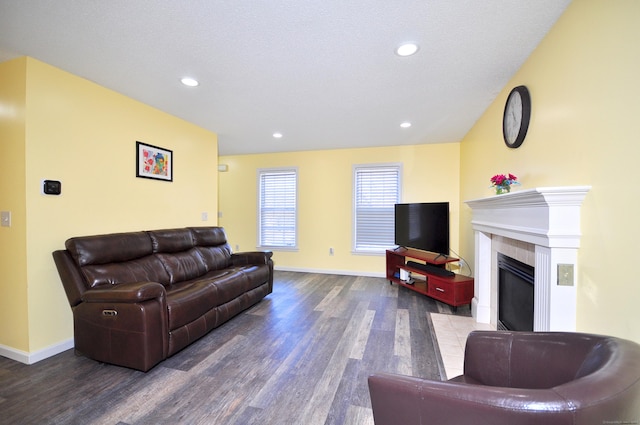 living area with recessed lighting, baseboards, a tiled fireplace, and wood finished floors