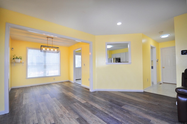 interior space with recessed lighting, wood finished floors, and baseboards