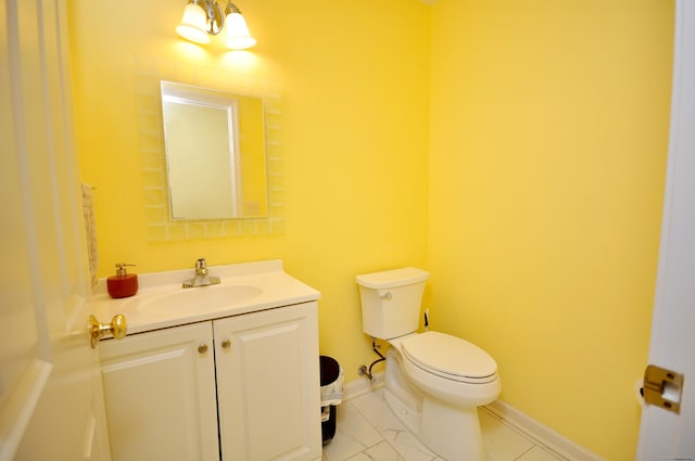 bathroom featuring marble finish floor, baseboards, vanity, and toilet