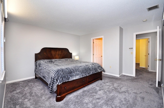 carpeted bedroom featuring visible vents, a textured ceiling, and baseboards