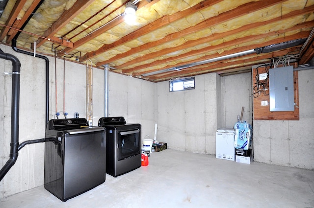 basement with electric panel and separate washer and dryer