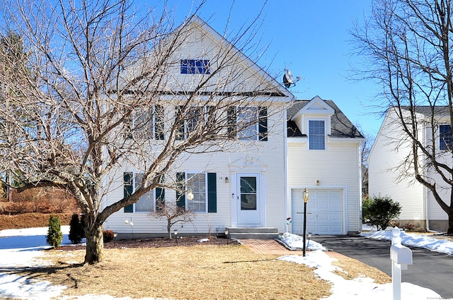 colonial house with driveway and an attached garage