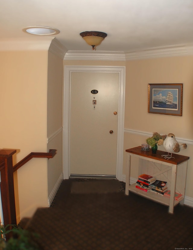 interior space featuring baseboards, dark colored carpet, and crown molding