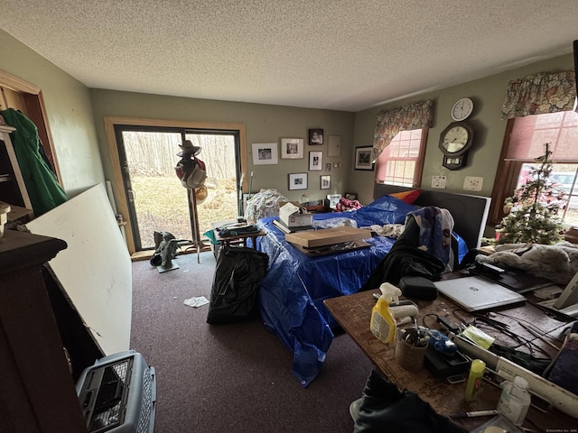 bedroom with a textured ceiling and carpet floors