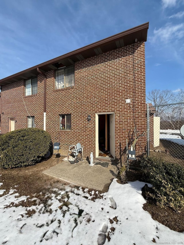 rear view of property with a patio area and brick siding