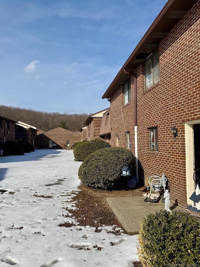 view of side of property featuring brick siding