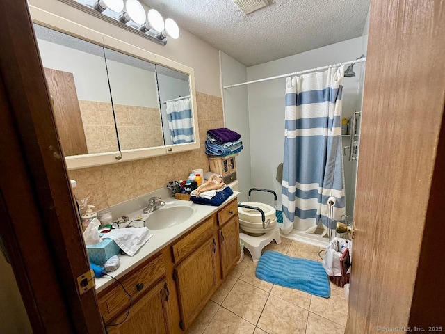 full bath with visible vents, a textured ceiling, vanity, a shower with curtain, and tile patterned floors