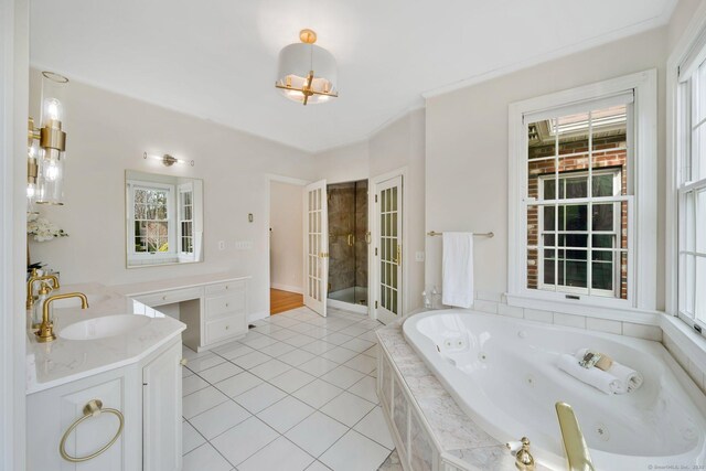 full bath featuring vanity, a tub with jets, and tile patterned flooring