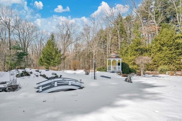 snowy yard featuring a gazebo