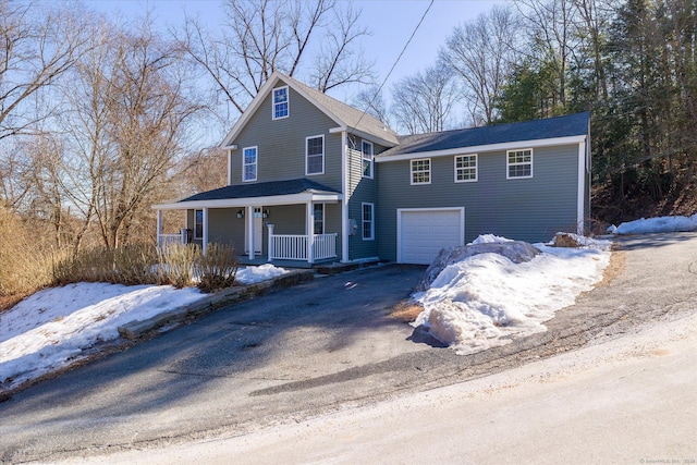 view of front of property with a porch, a garage, and aphalt driveway