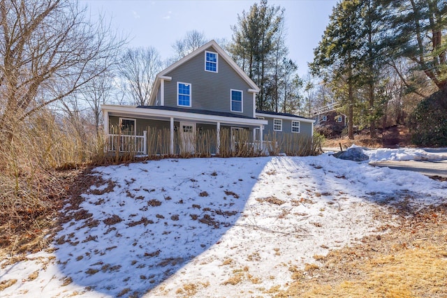 snow covered house with covered porch