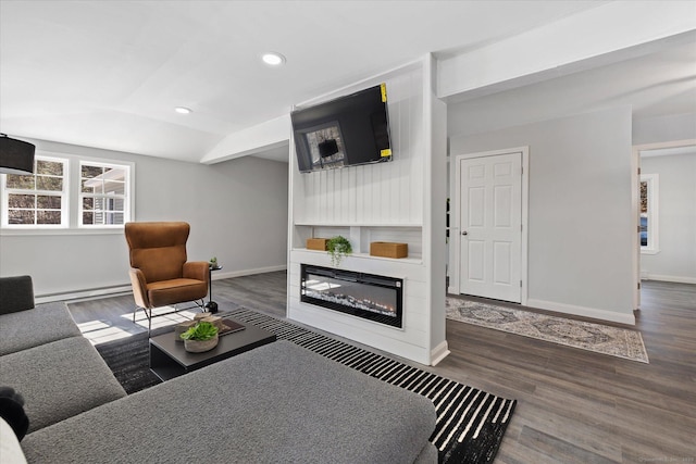 living room featuring recessed lighting, baseboards, wood finished floors, and a glass covered fireplace