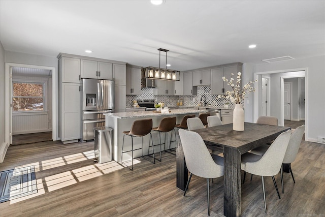 dining area featuring recessed lighting, visible vents, and wood finished floors