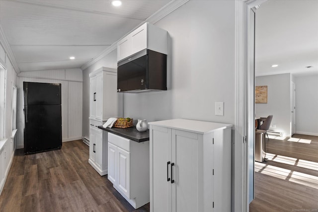 kitchen with dark wood-style floors, freestanding refrigerator, white cabinets, and vaulted ceiling