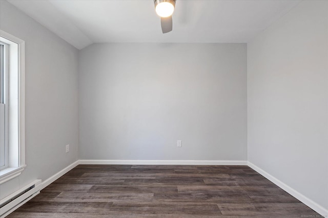 empty room with a baseboard radiator, vaulted ceiling, baseboards, and wood finished floors