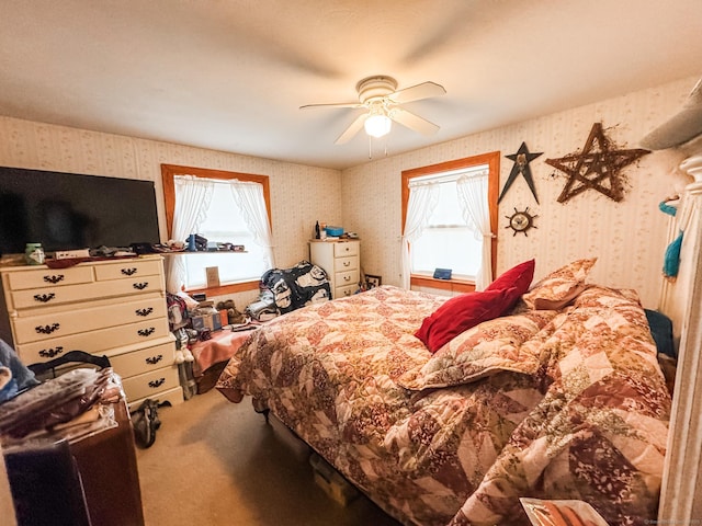 bedroom with carpet floors, ceiling fan, and wallpapered walls