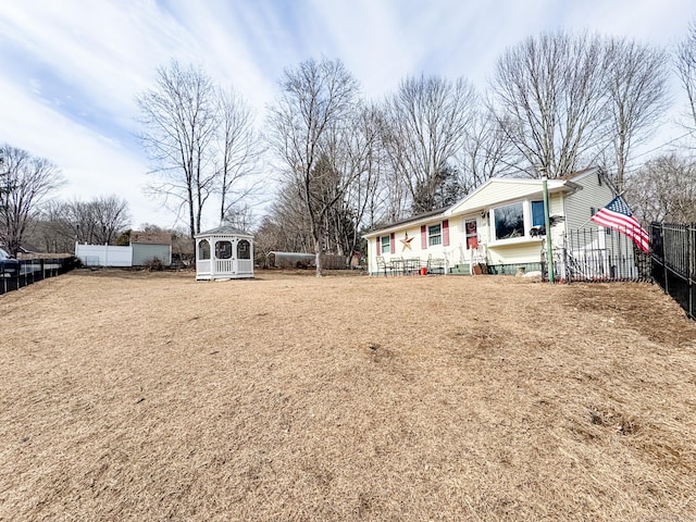 exterior space with a gazebo, a yard, and a fenced backyard