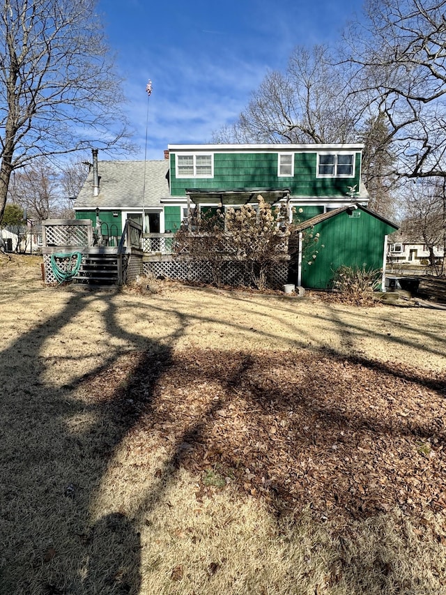 back of house featuring a wooden deck