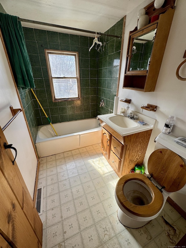 bathroom with vanity, visible vents, shower / washtub combination, tile patterned floors, and toilet