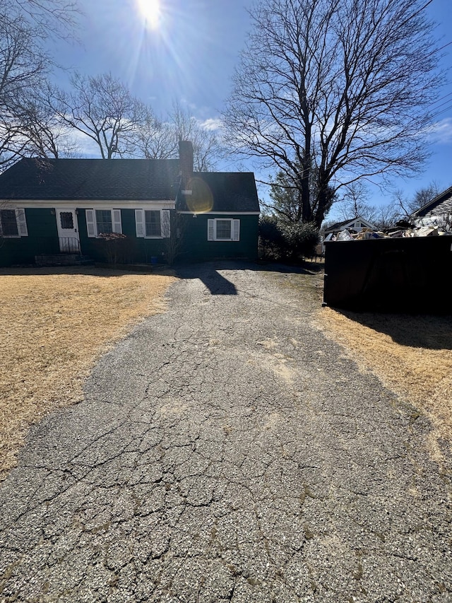 view of front of property with aphalt driveway and a chimney