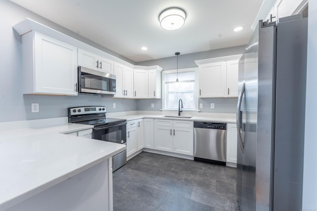 kitchen featuring white cabinets, stainless steel appliances, a sink, and light countertops