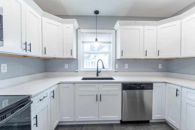 kitchen featuring a sink, white cabinetry, light countertops, stainless steel dishwasher, and decorative light fixtures