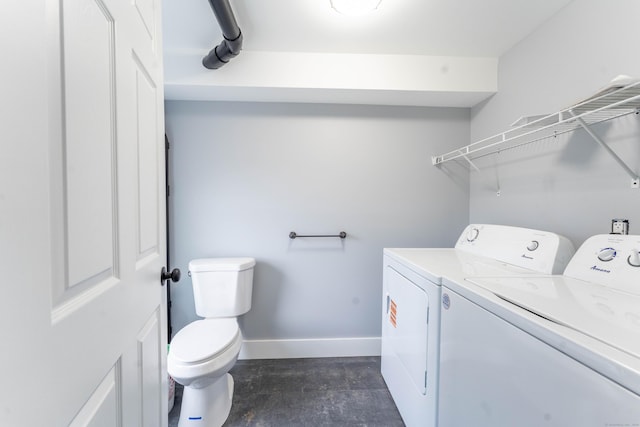 laundry area featuring washing machine and dryer, laundry area, and baseboards