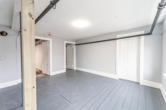 finished basement with hardwood / wood-style flooring and baseboards