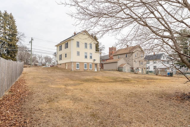 back of property featuring fence and a chimney