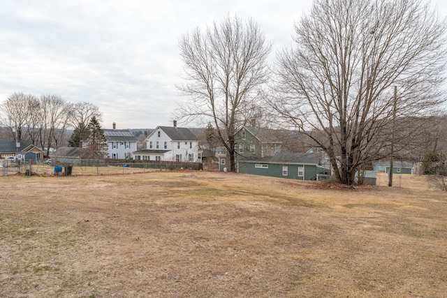 view of yard featuring a residential view and fence