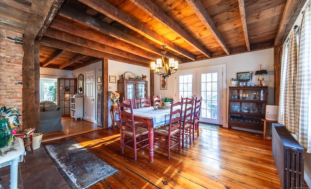 dining space featuring radiator, beamed ceiling, french doors, wooden ceiling, and wood-type flooring