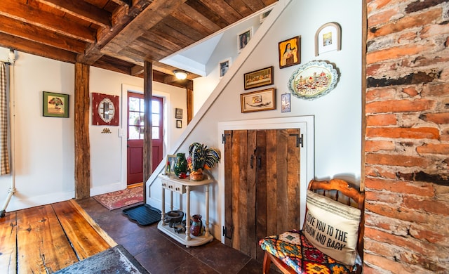 interior space featuring beamed ceiling, visible vents, and baseboards