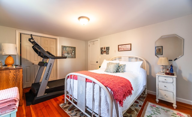 bedroom with wood finished floors and baseboards