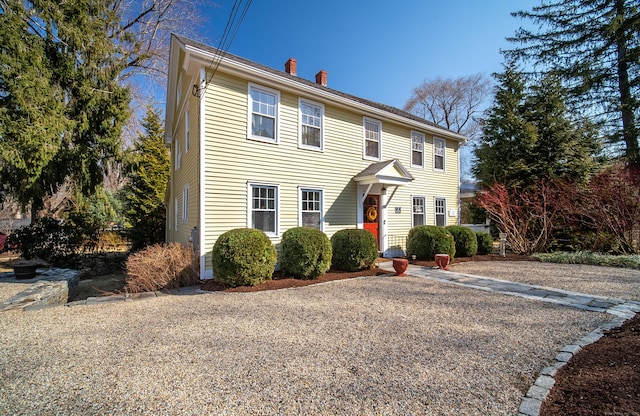 colonial house featuring a chimney