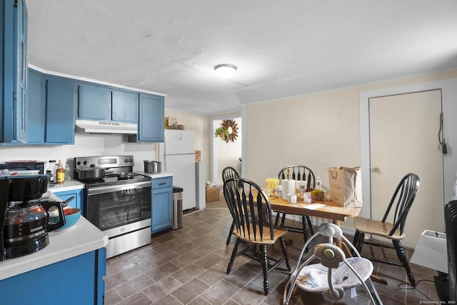 kitchen with freestanding refrigerator, blue cabinets, light countertops, stainless steel range with electric cooktop, and under cabinet range hood