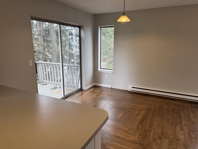 unfurnished dining area featuring baseboards and baseboard heating