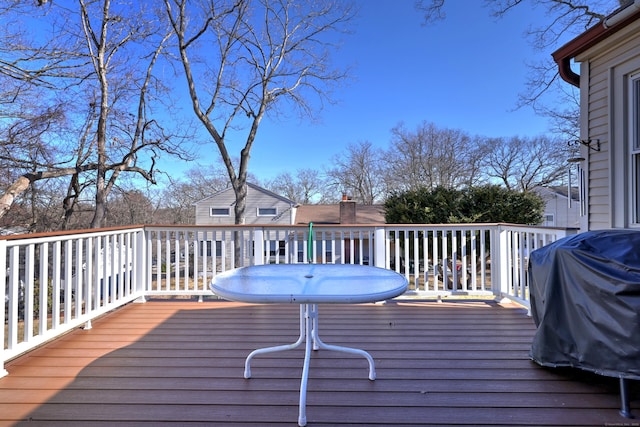 wooden deck featuring a grill