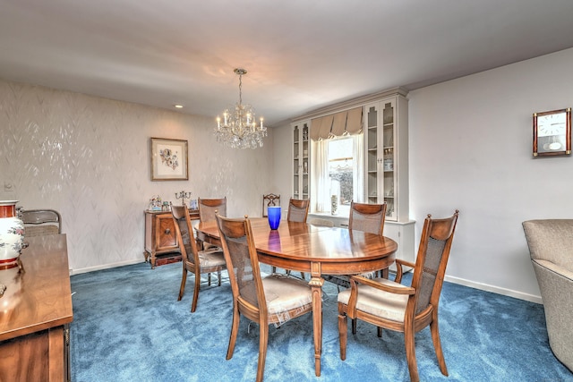 dining area with a notable chandelier, baseboards, and carpet