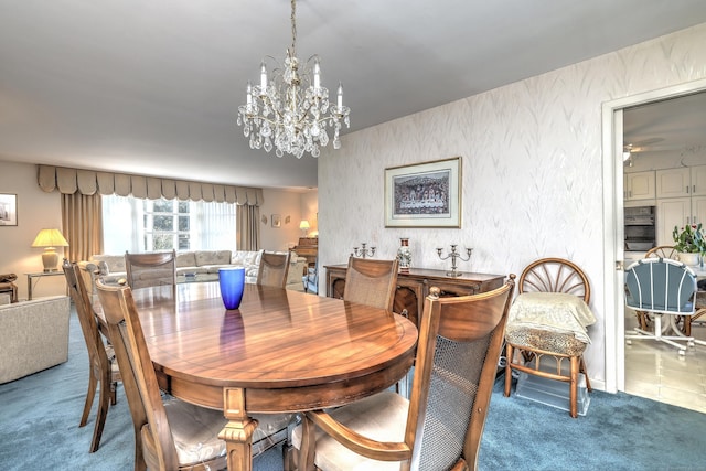 carpeted dining space featuring a notable chandelier and a textured wall