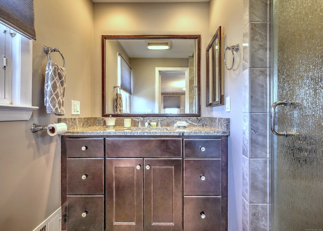 full bath with vanity and a shower stall