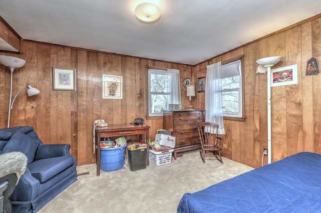 carpeted bedroom featuring wood walls